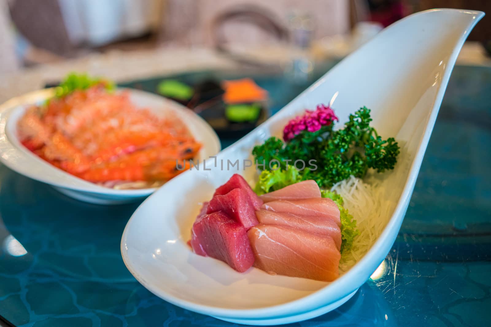 A plate of tuna and salmond sashimi served in a Japanese restaurant