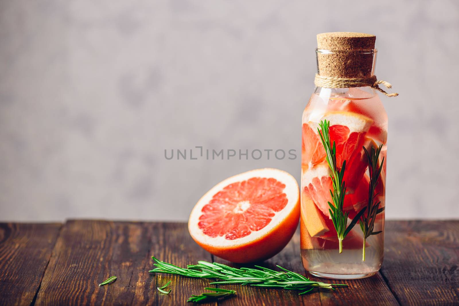 Summer Drink with Refreshing Raw Grapefruit and Fresh Rosemary. Copy Space on the Left Side.