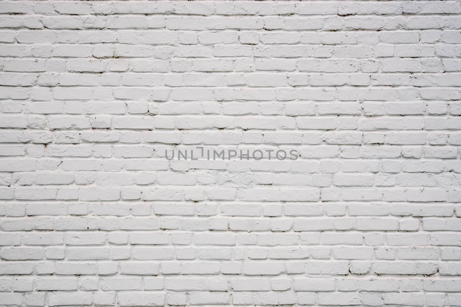 Background or backdrop of white chipped brick wall.