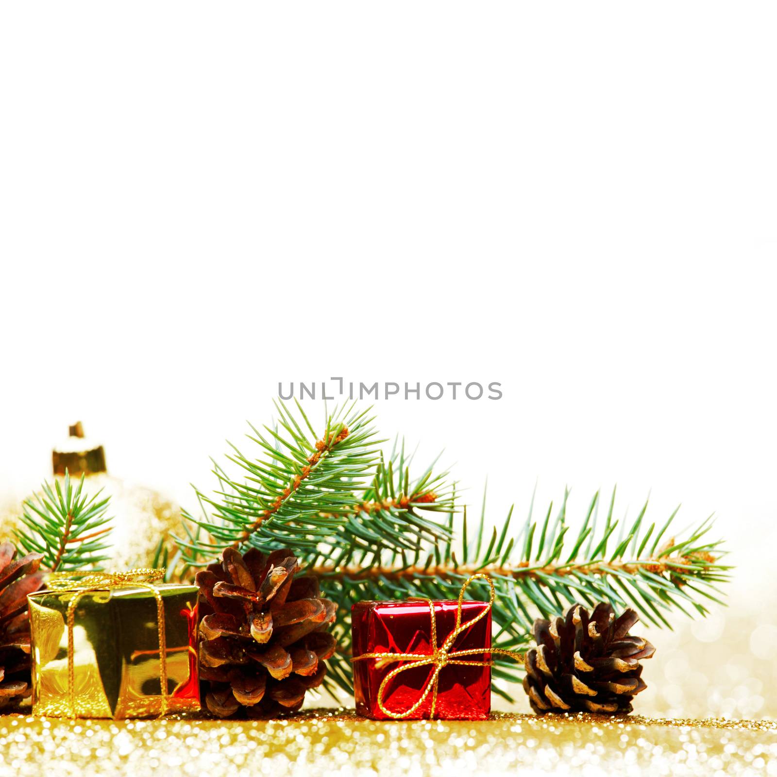 Christmas card with fir tree branch and decoration on golden glitter background
