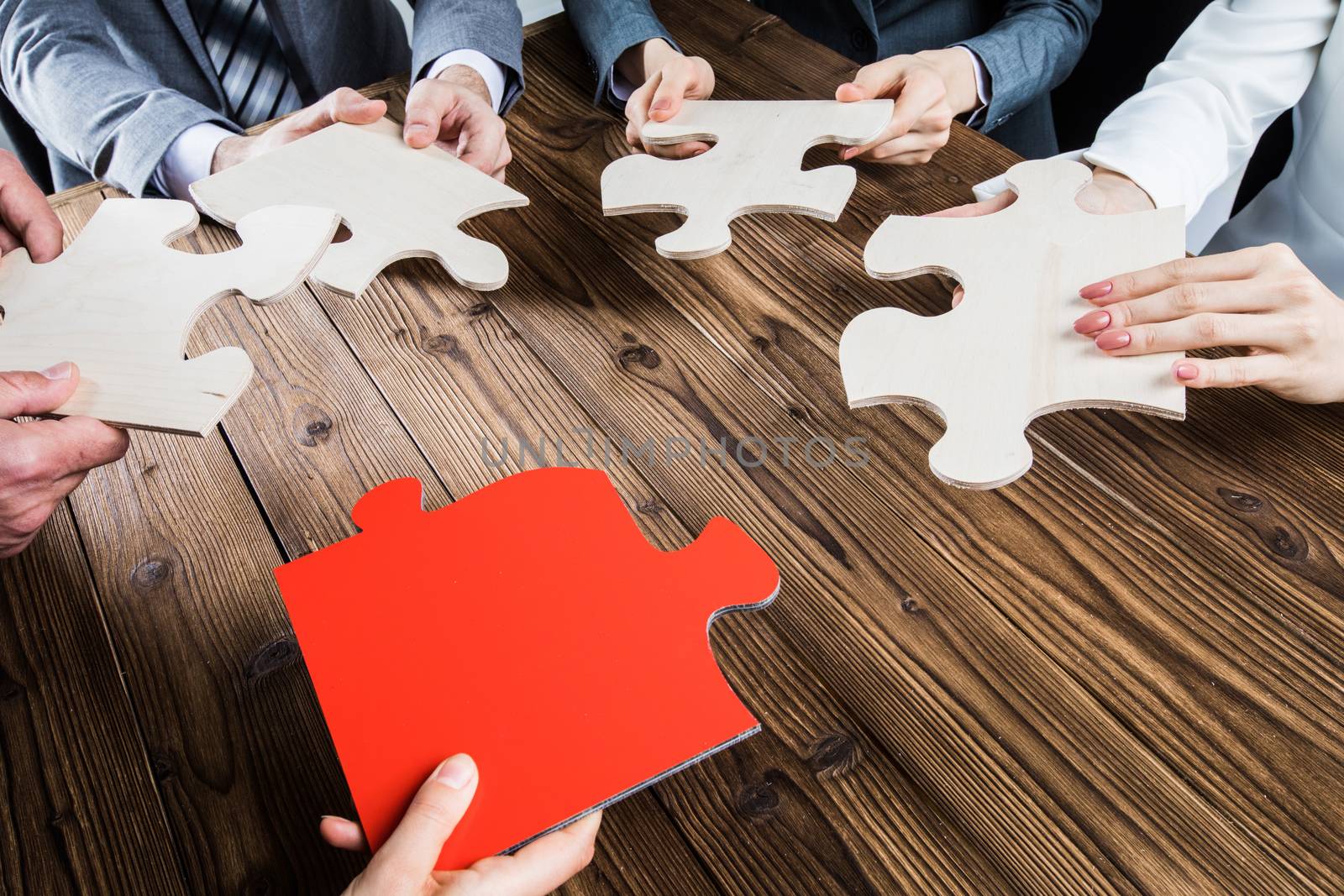 Business people assembling jigsaw puzzle by Yellowj
