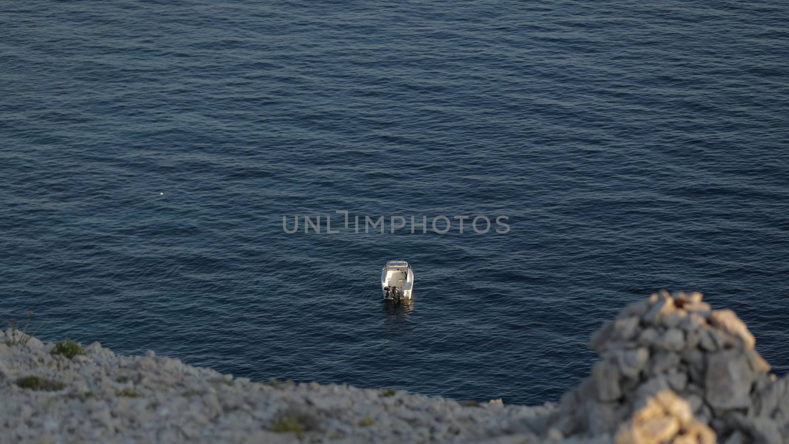 Small launch boat with people, blue sea, rocky coast by tema_rebel