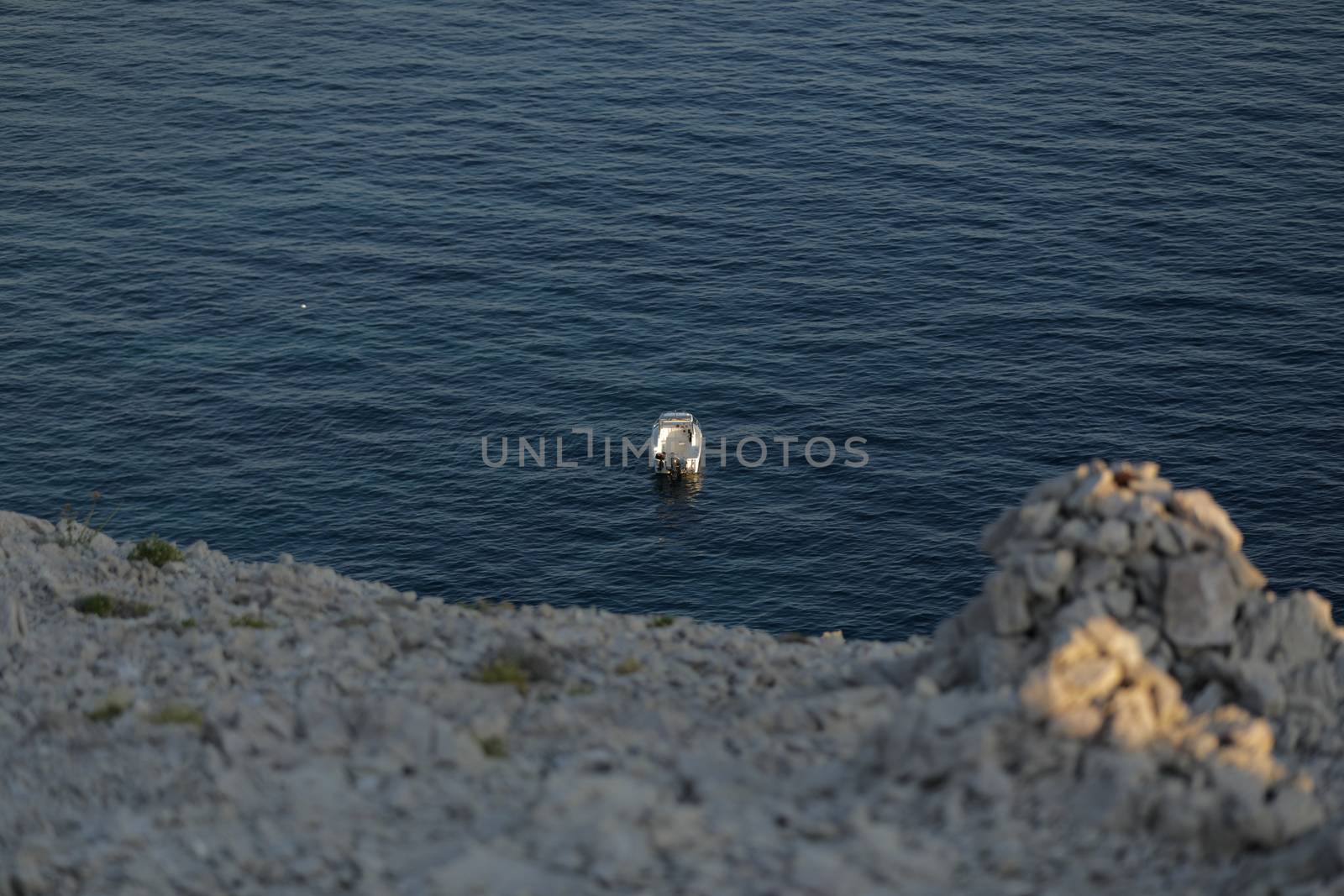 Small launch boat with people, blue sea, rocky coast by tema_rebel