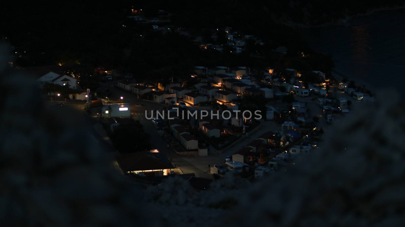 Night view onto the cars camping from the rocky hill in Croatia by tema_rebel