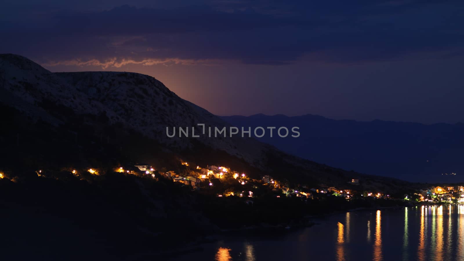 Night view under the moon light onto the city on a shore of Adriatic sea from the rocky hill in Croatia, different color tones by tema_rebel