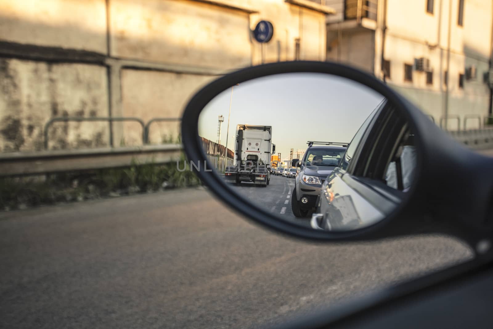 Road traffic seen in the rear-view mirror
