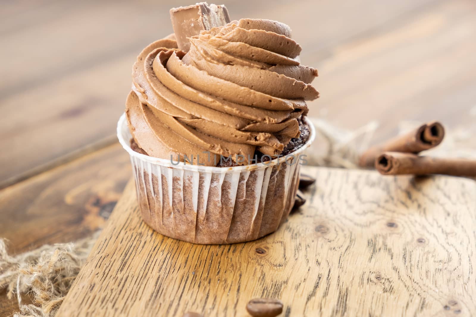 brown cupcakes with cocoa cream, cinnamon and coffee