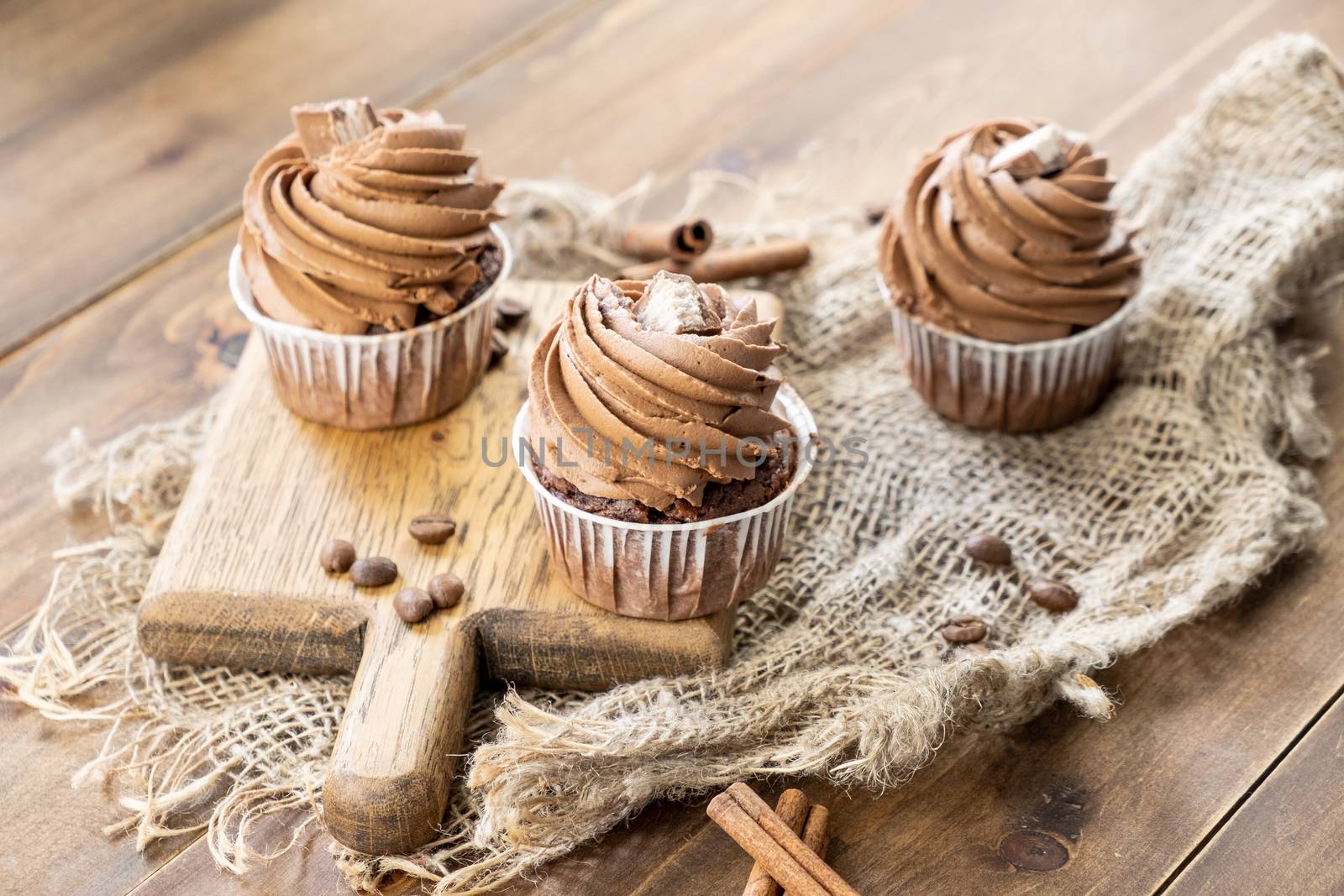 brown cupcakes with cocoa cream, cinnamon and coffee