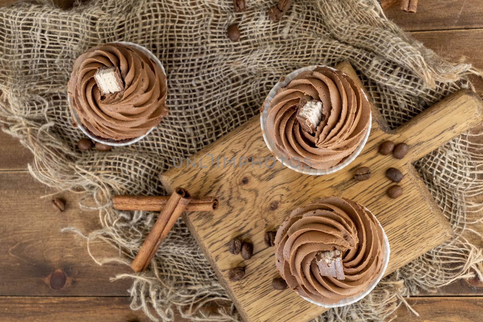 brown cupcakes with cocoa cream, cinnamon and coffee