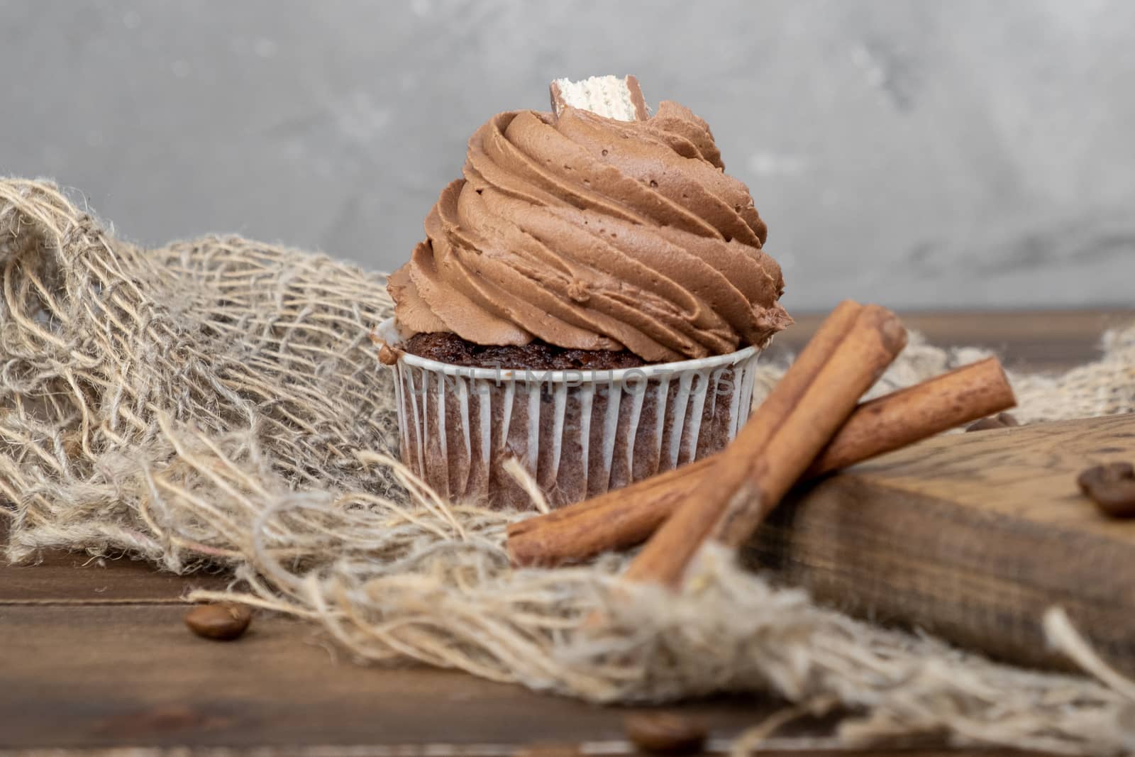 brown cupcakes with cocoa cream, cinnamon and coffee