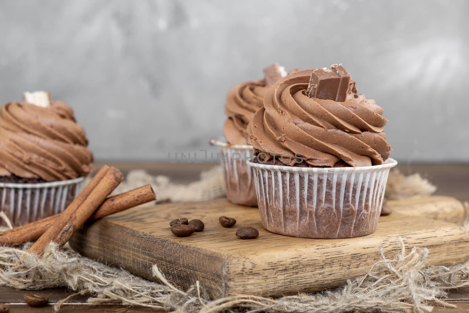 brown cupcakes with cocoa cream, cinnamon and coffee