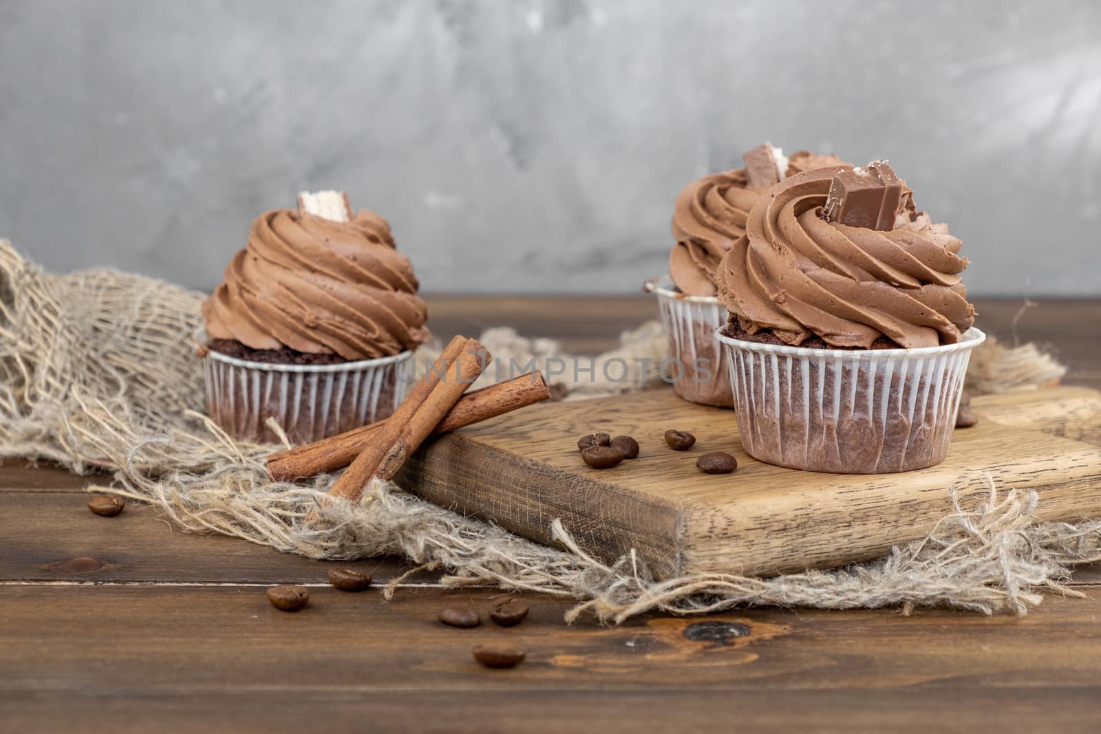 brown cupcakes with cocoa cream, cinnamon and coffee