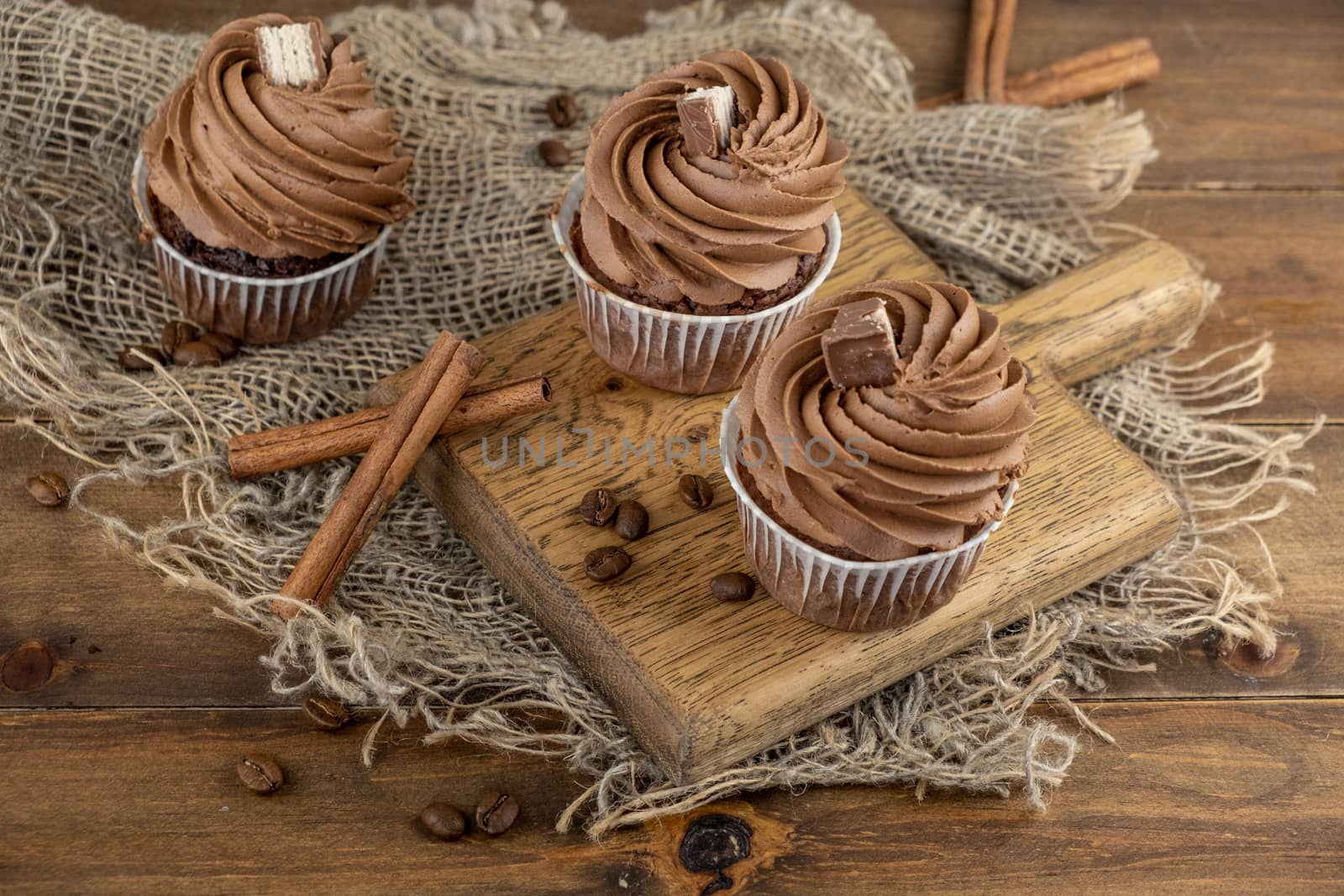 brown cupcakes with cocoa cream, cinnamon and coffee