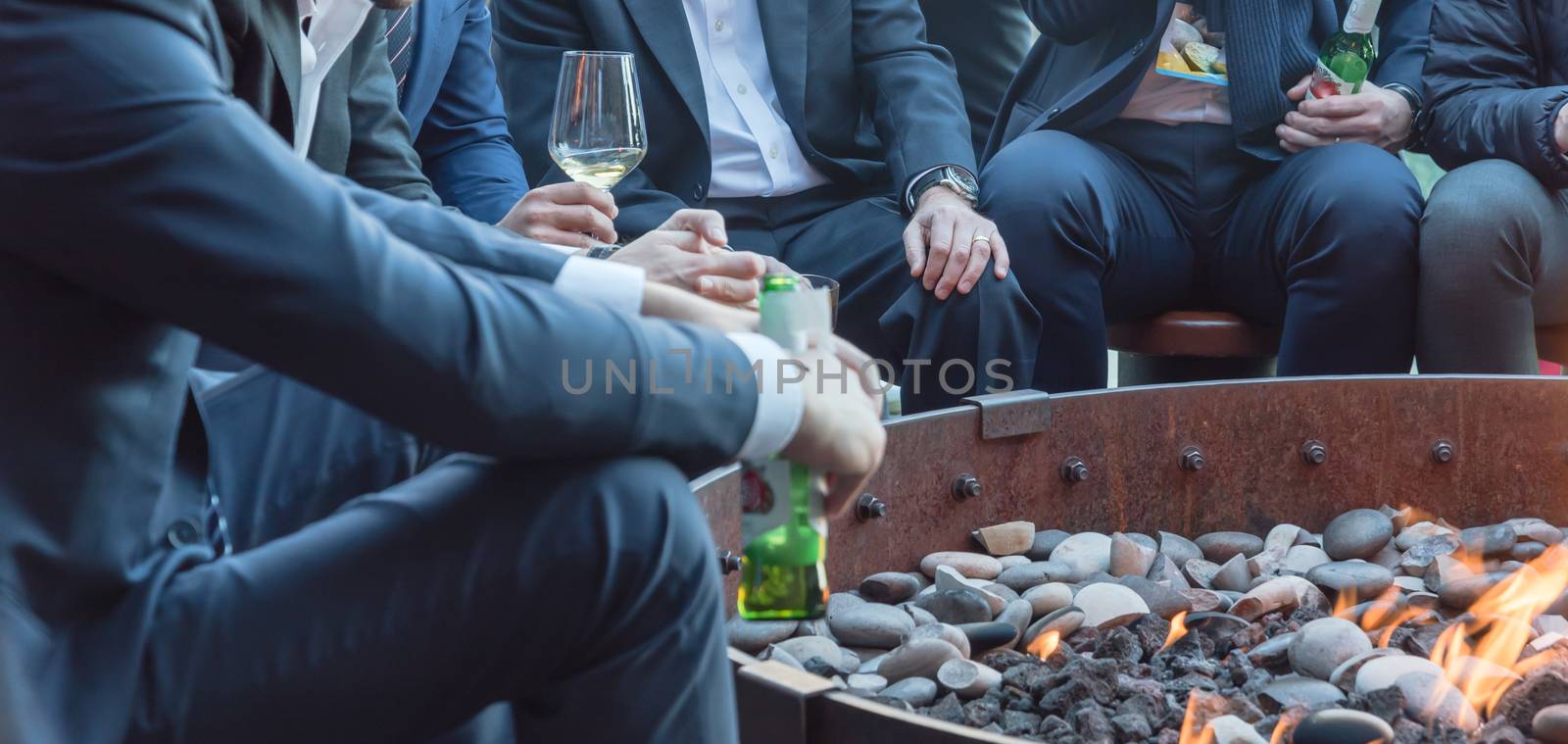 Businesspeople hangout near patio fire pit at wintertime in Chicago, America by trongnguyen