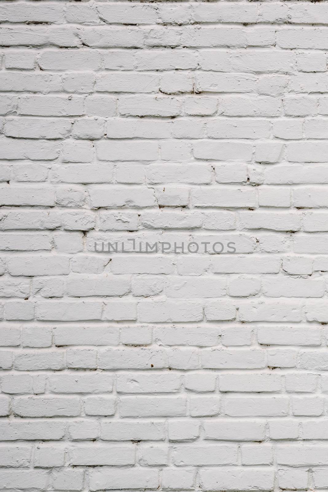 Background or texture of White Chipped Brick Wall.