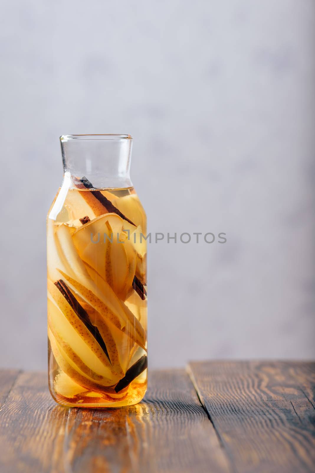 Water Flavored with Pear, Ginger Root and Cinnamon Stick. Vertical Orientation and Copy Space.
