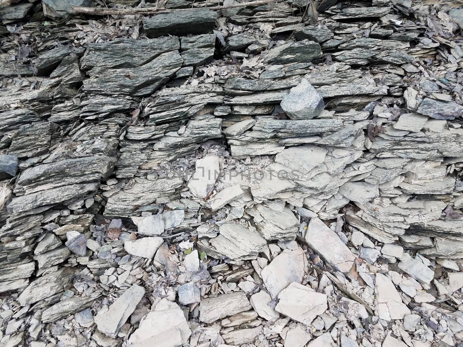 broken or chipped grey rocks on the ground by stockphotofan1