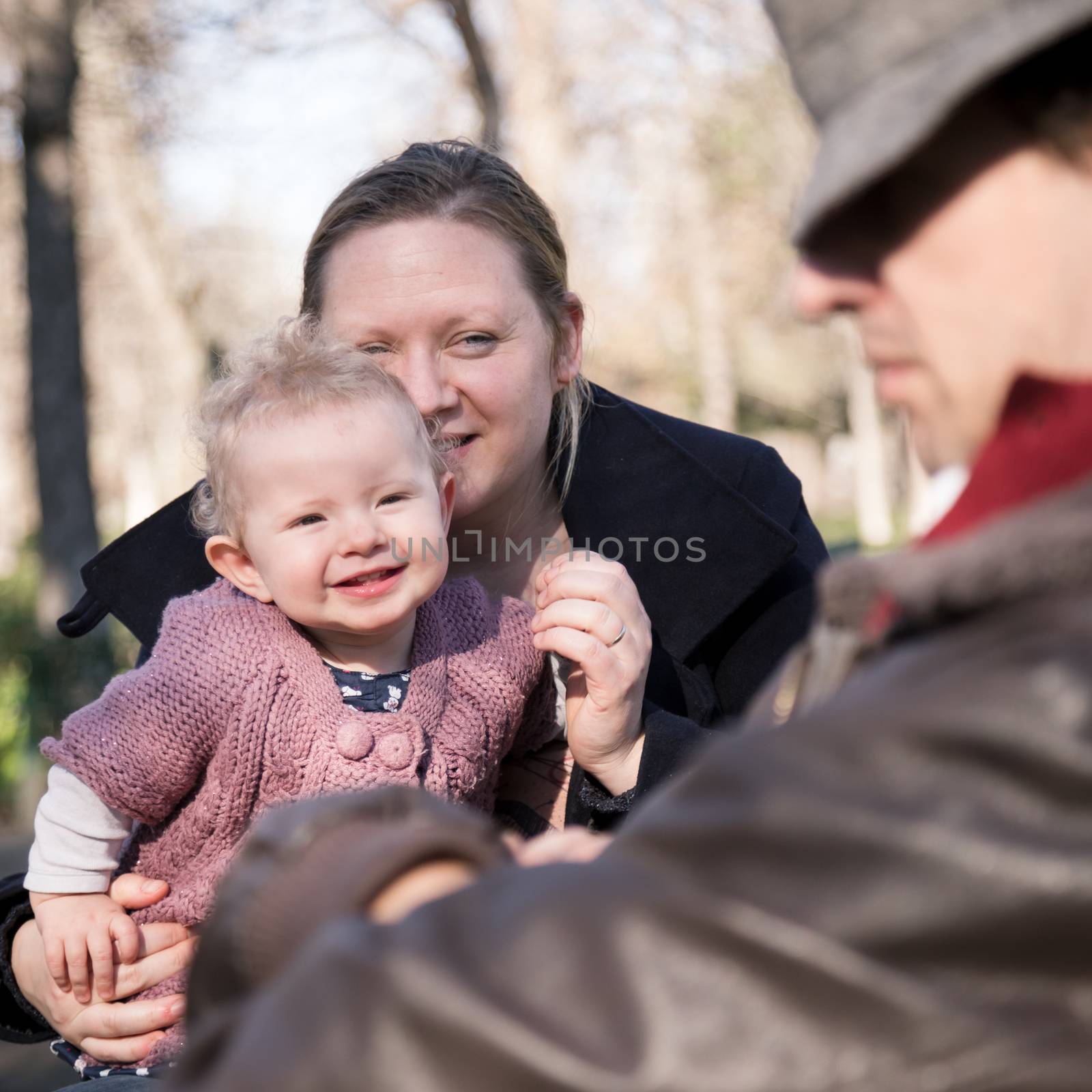 Young family with cheerful child in the park. by kasto