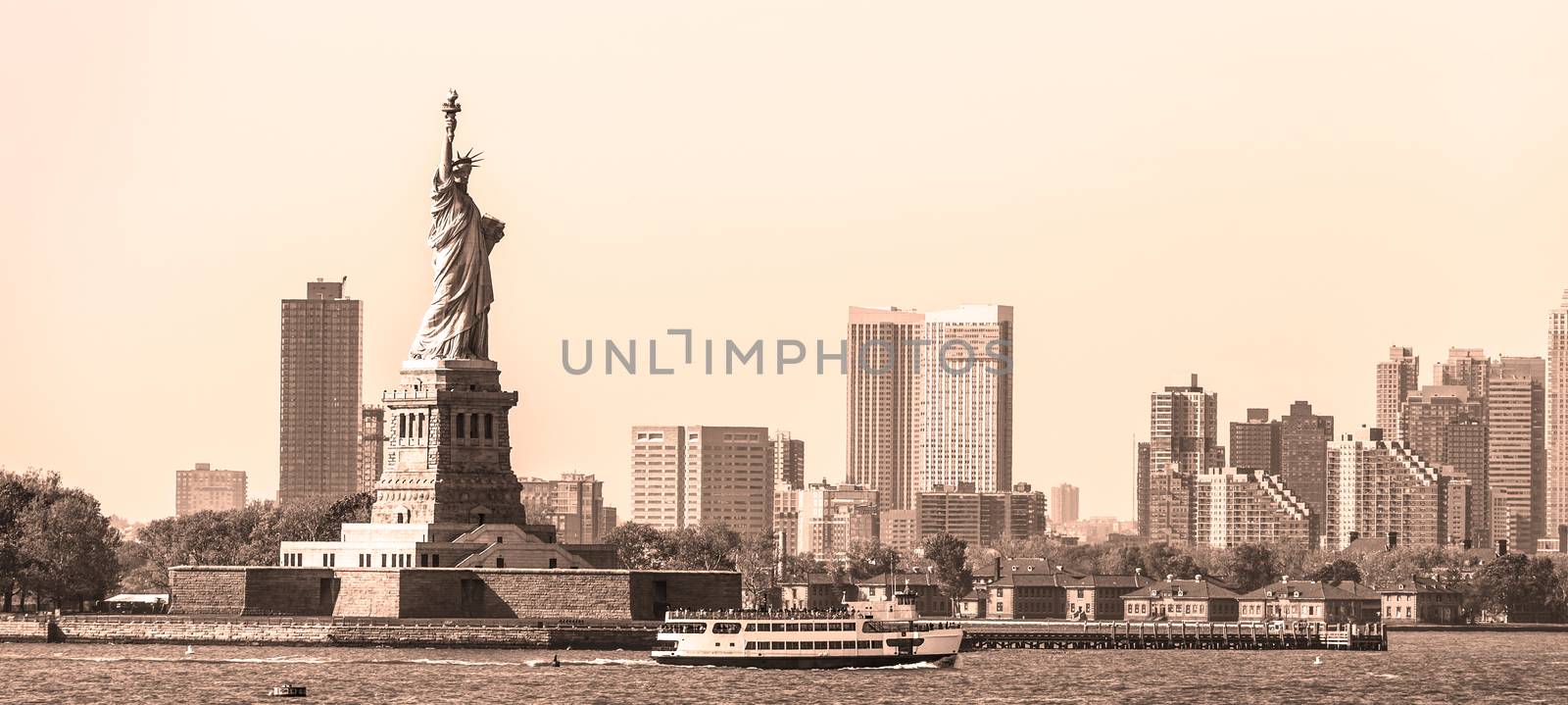 Statue of Liberty with Liberty State Park and Jersey City skyscrapers in background, USA. Black and white yellow toned image.