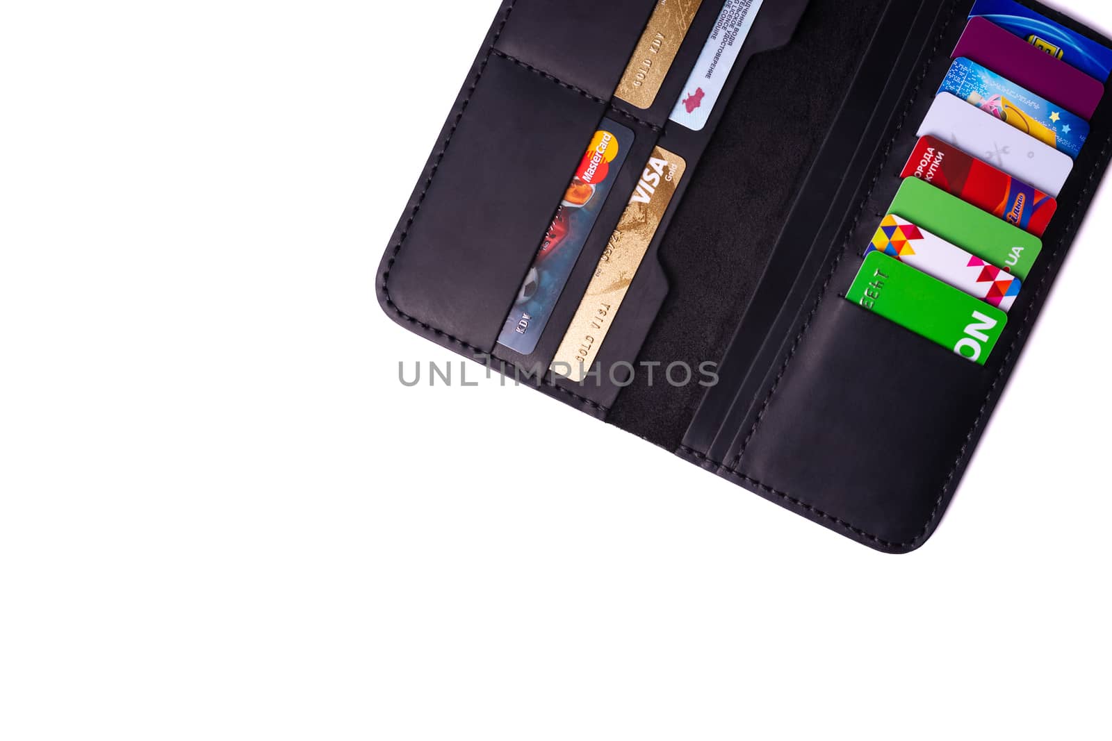 24.01.2019 Ukraine, Kyiv. A part of handmade black leather wallet isolated on white background closeup. A lot of plastic cards in purse pockets. Editorial use only.