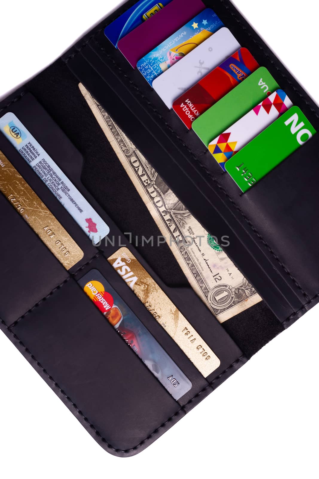 24.01.2019 Ukraine, Kyiv. A part of handmade black leather wallet isolated on white background closeup. A lot of plastic cards in purse pockets. Editorial use only.