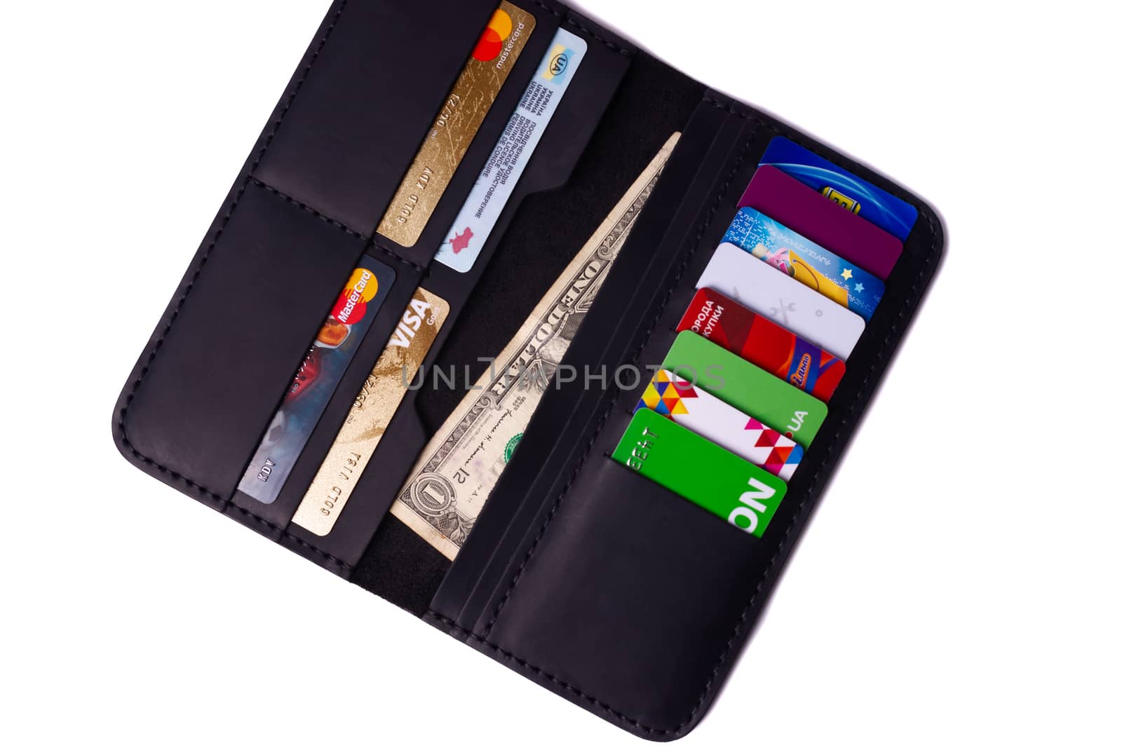 24.01.2019 Ukraine, Kyiv. A part of handmade black leather wallet isolated on white background closeup. A lot of plastic cards in purse pockets. Editorial use only.