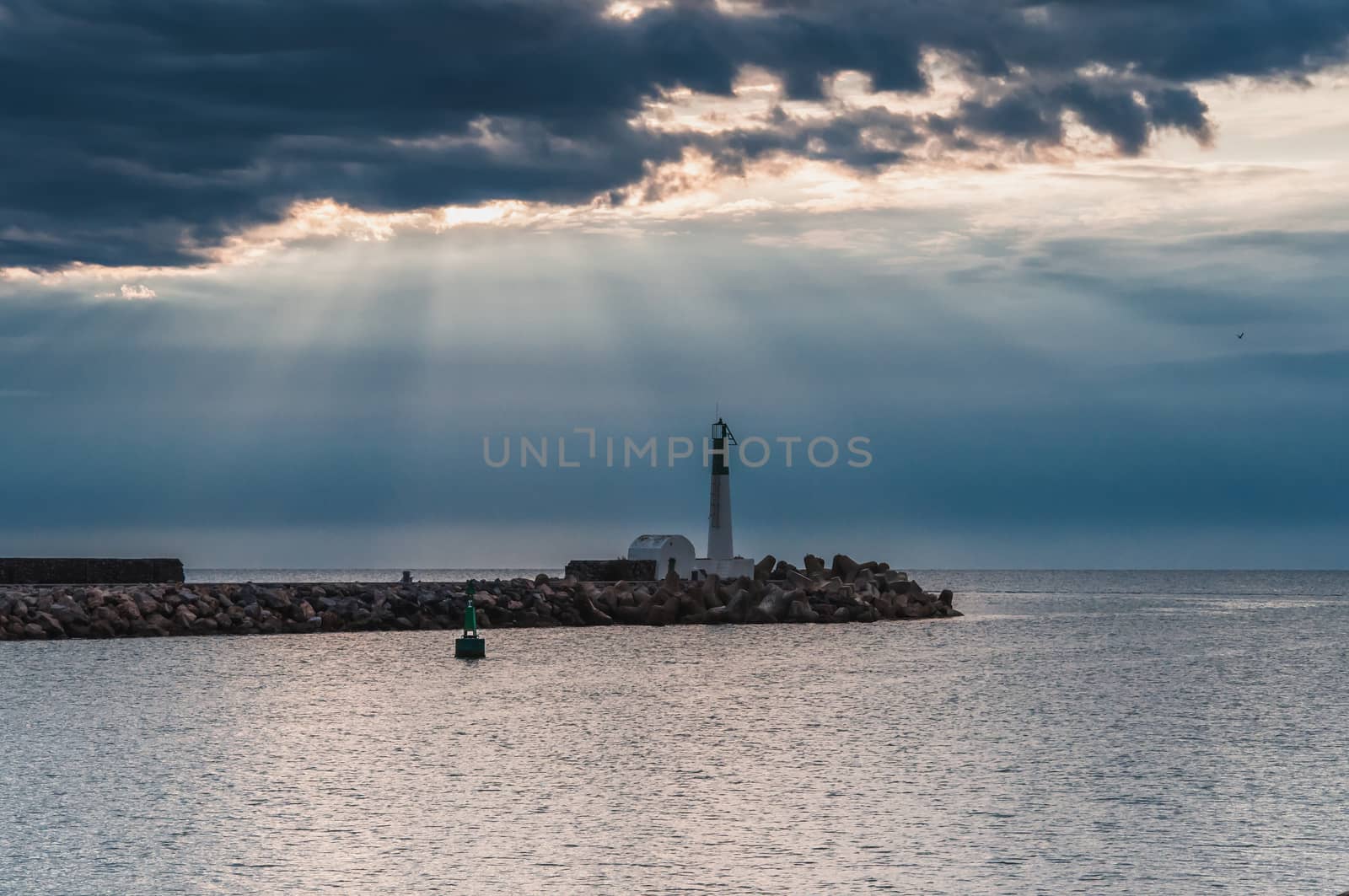 Lighthouse of Port-La-Nouvelle in red and white on cloudy sky in Occitanie, France