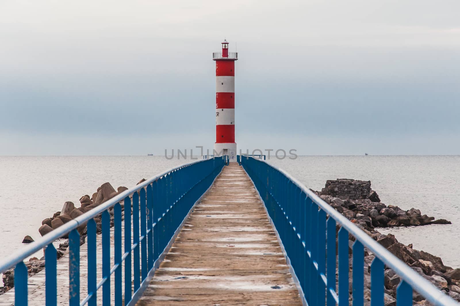 Lighthouse of Port-La-Nouvelle in red and white on cloudy sky in Occitanie, France