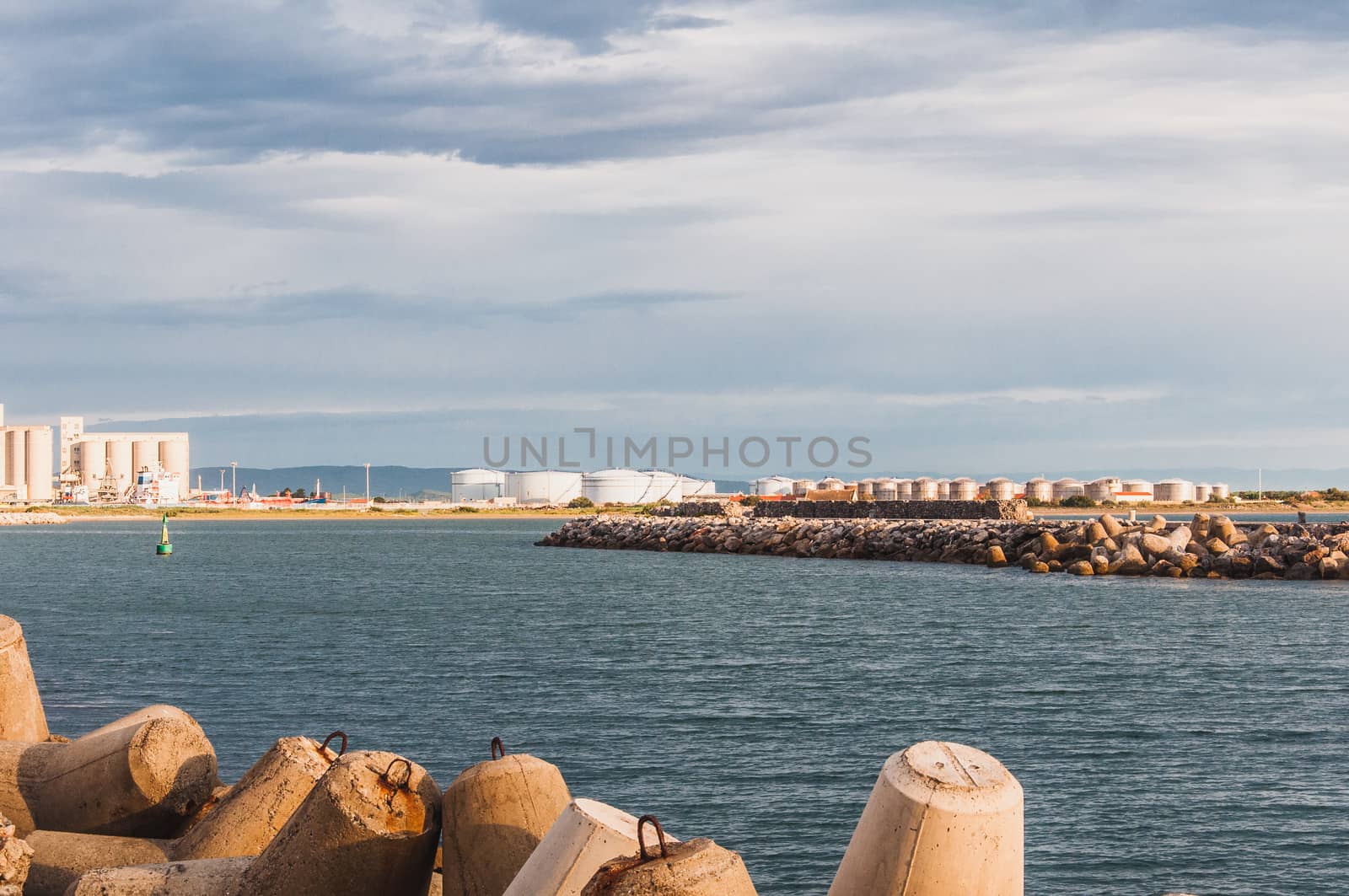 Lighthouse of Port-La-Nouvelle in red and white on cloudy sky in Occitanie, France