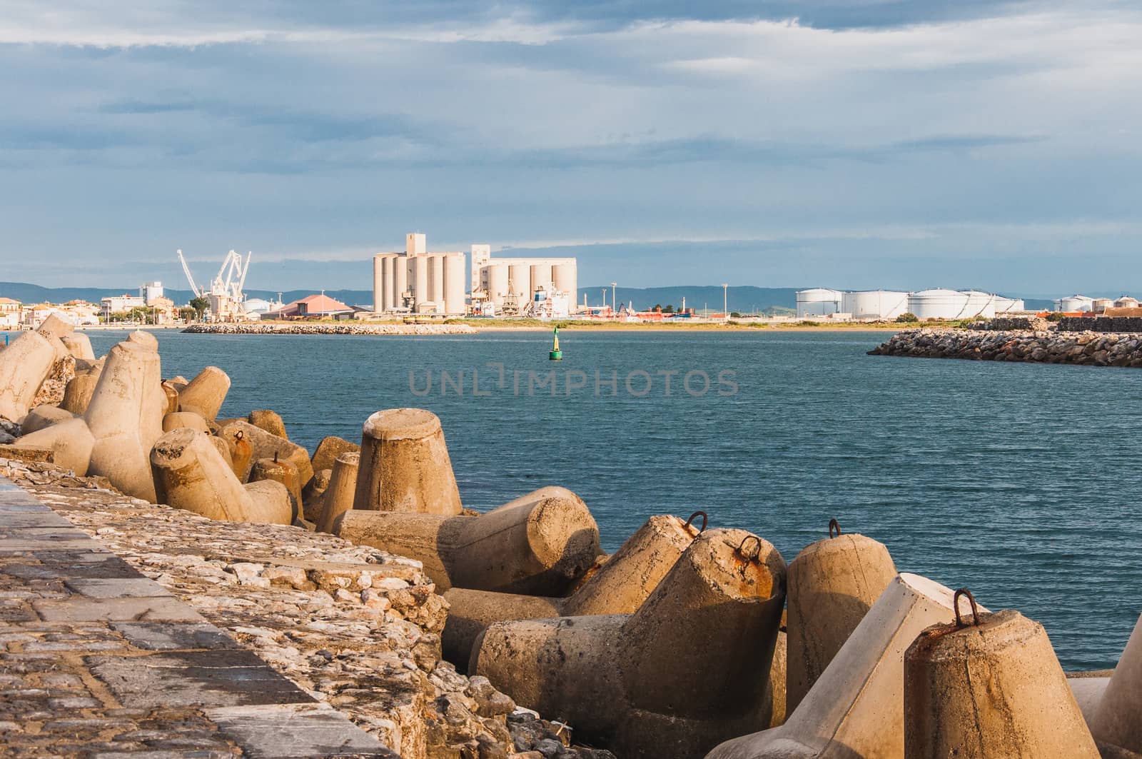 Lighthouse of Port-La-Nouvelle in red and white on cloudy sky in Occitanie, France