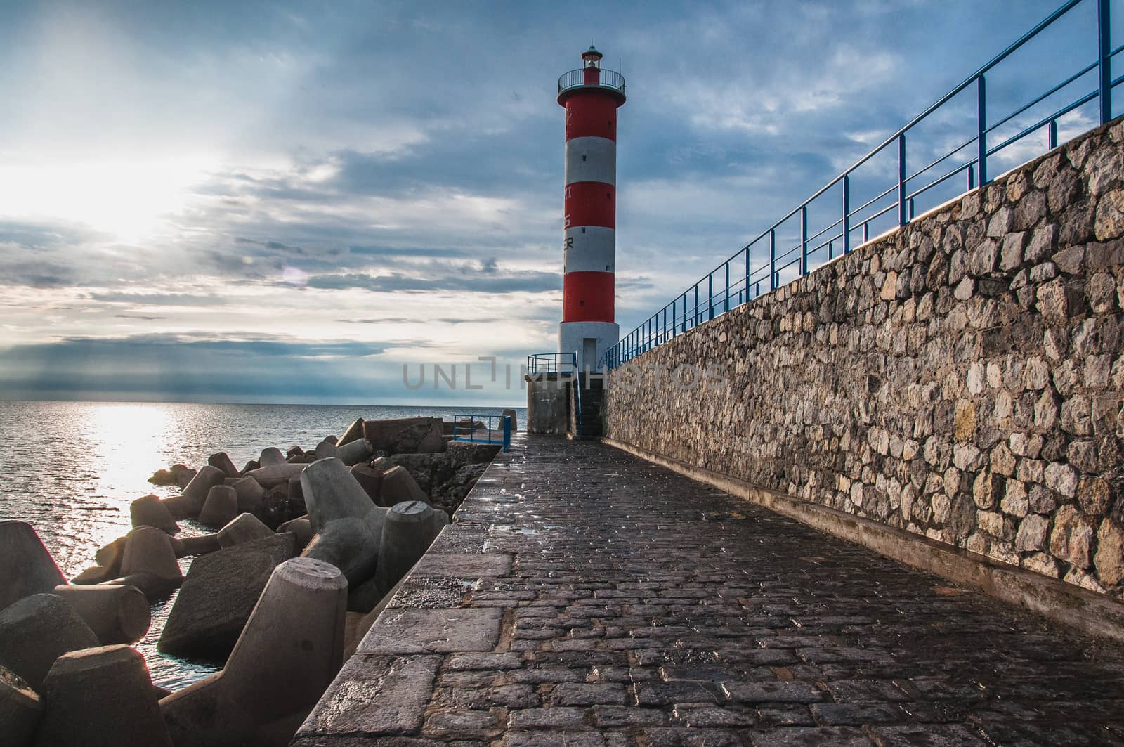 Lighthouse of Port-La-Nouvelle in red and white on cloudy sky in Occitanie, France