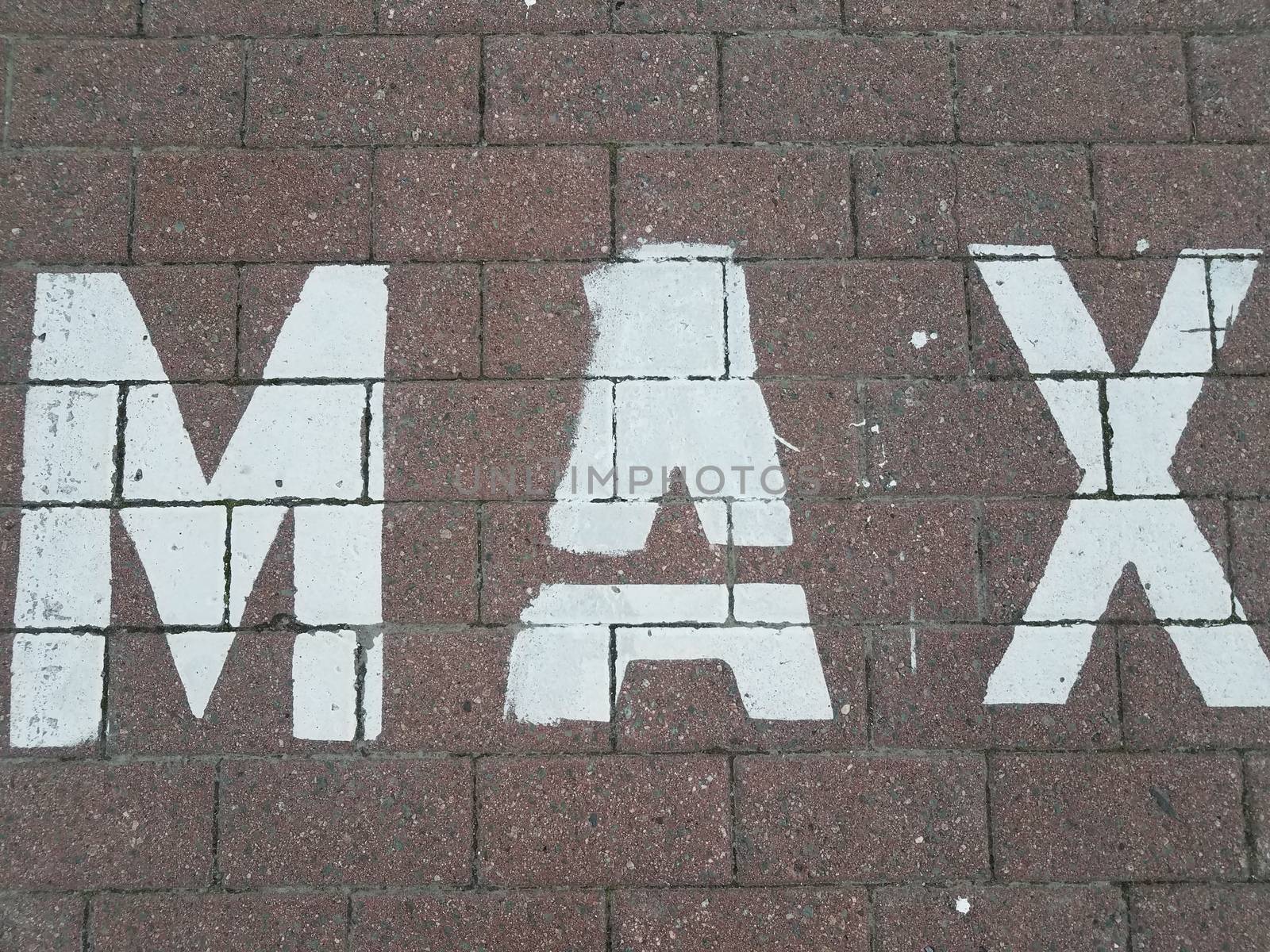 white painted max on bricks or tiles on ground or floor