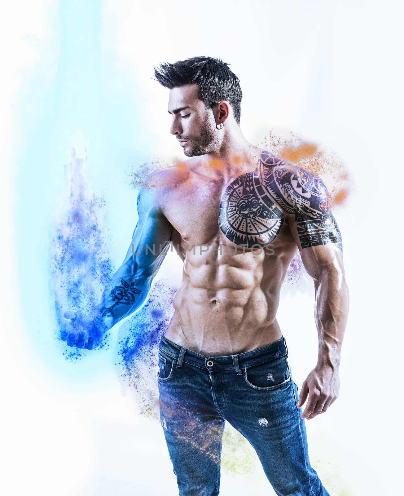 Handsome tattooed shirtless man holding illusion of blue energy light in his hand, isolated on white background