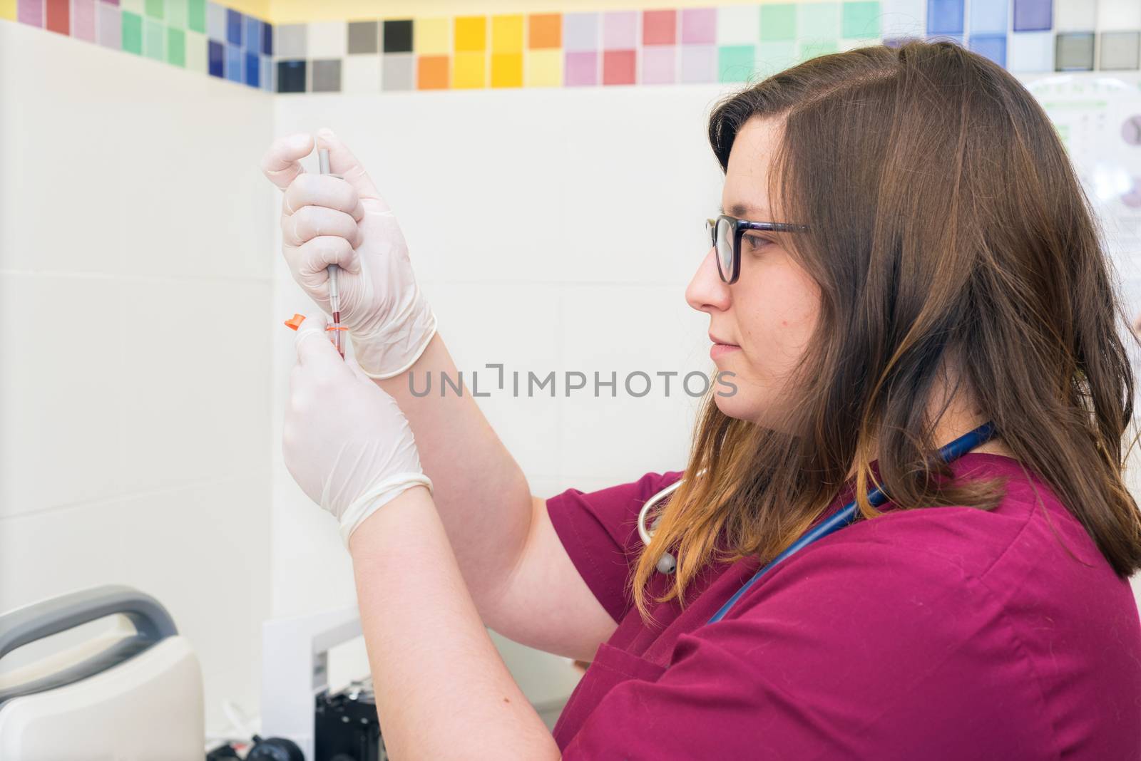 Female doctor working at laboratory. Blood test.