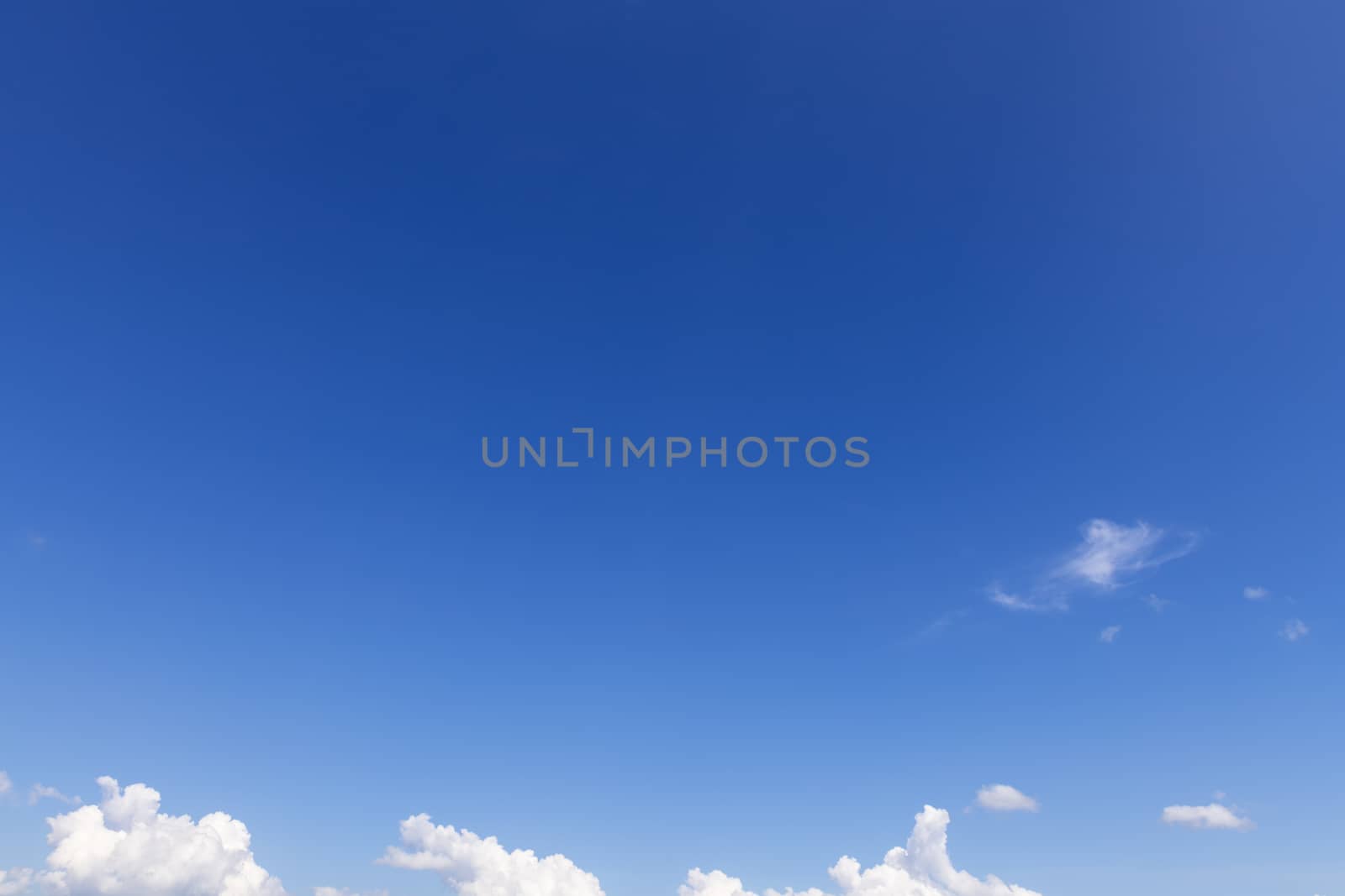 Summer blue sky with soft white clouds background.