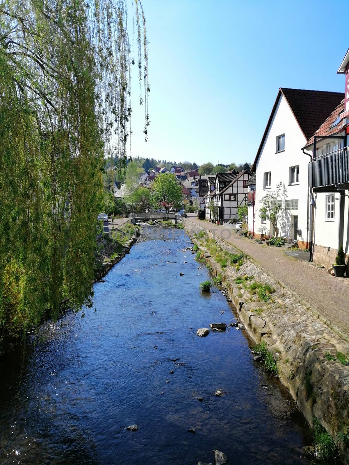 street with old houses in historic city of Kaufungen, Germany by Lenkapenka