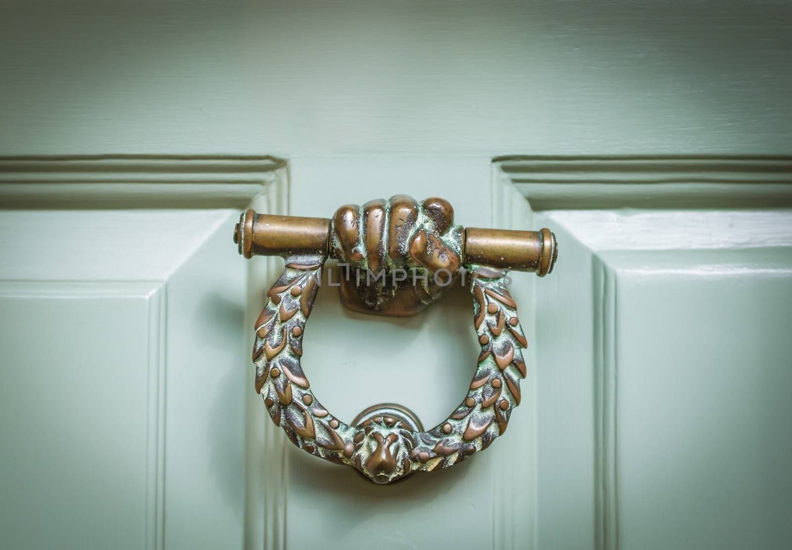 Ornate Brass Door Knocker On A Mint Green Door In Middle England