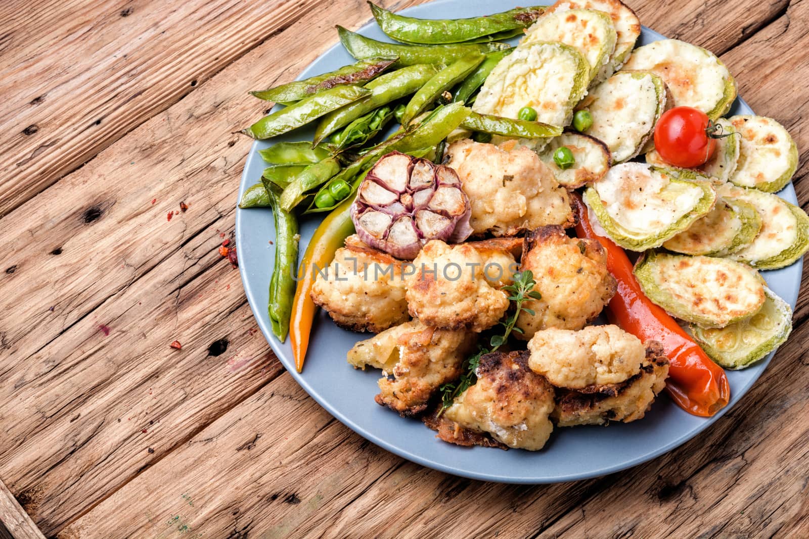 Grilled peas,roasted cauliflower and zucchini.Grill vegetables.Summer food.Large portion grilled vegetables