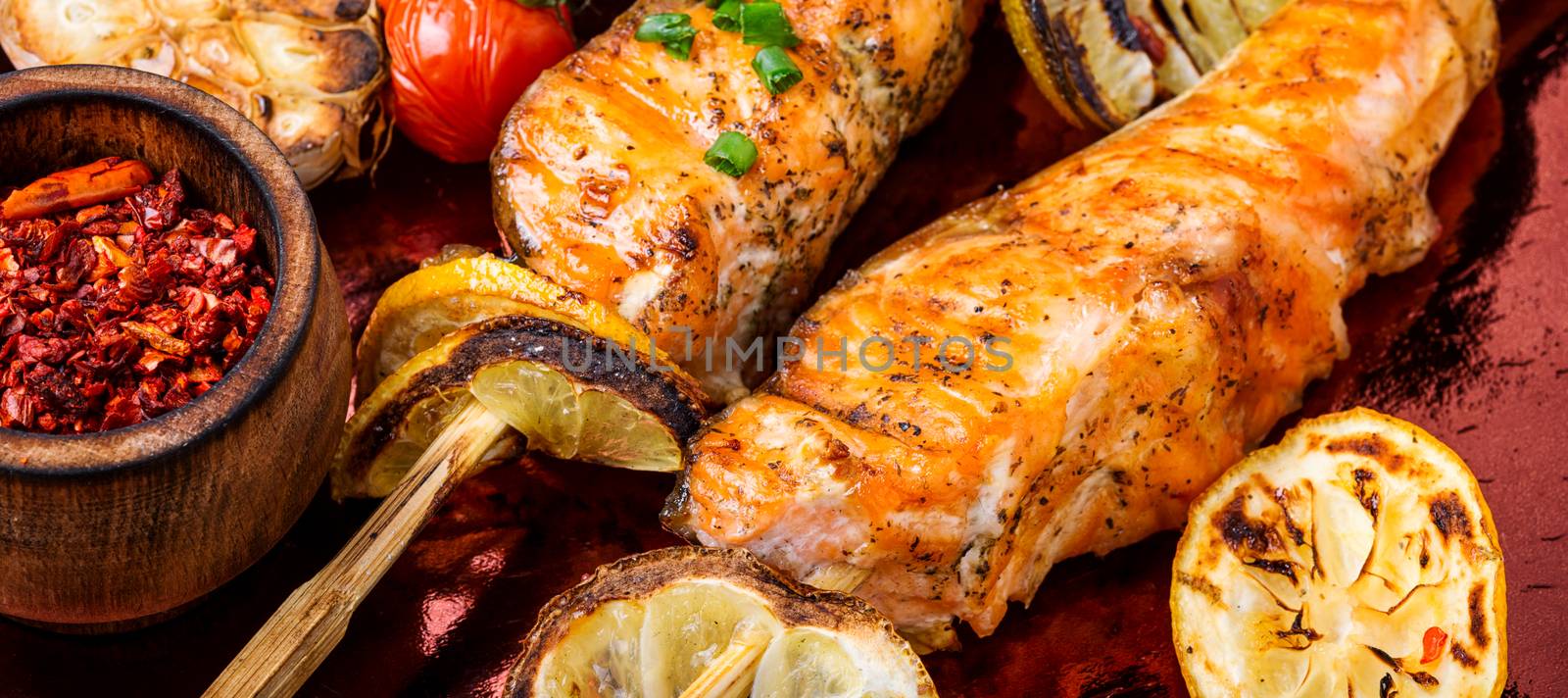 Grilled fish, grilled salmon steak with addition of lemon.Closeup