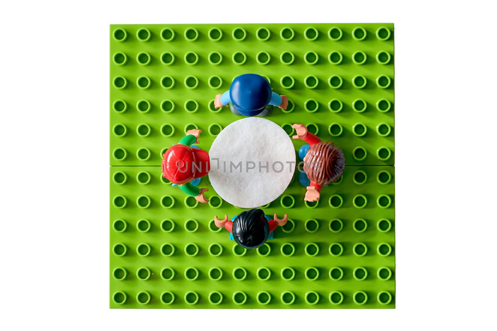 Donetsk, Ukraine - February 28, 2019: Studio daylight shooting of Lego people toys business meeting at office around the table. Business meeting consept, teamwork, planning and working.