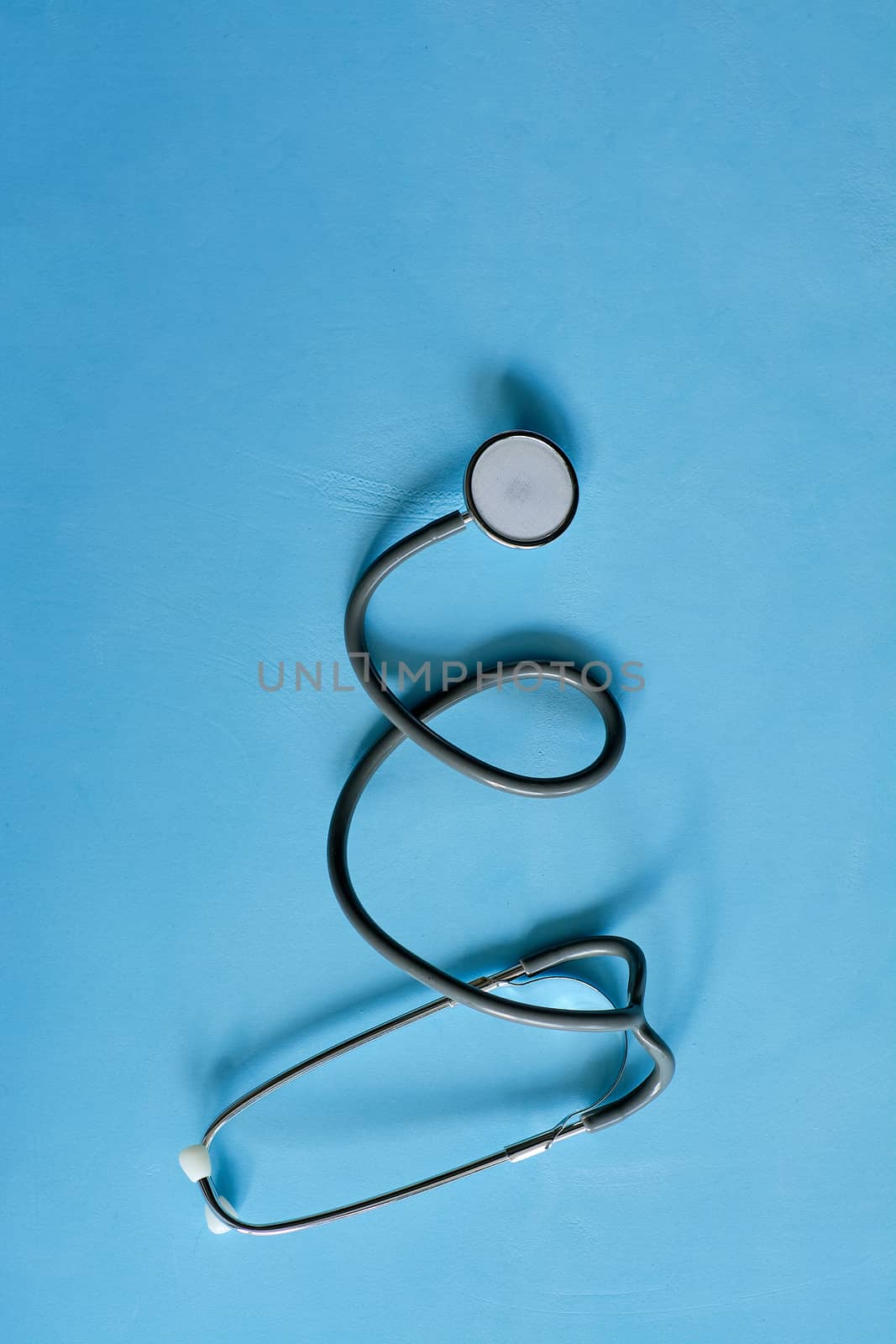 Phonendoscope stethoscope on blue background with copy space for text. Health life medicine concept.