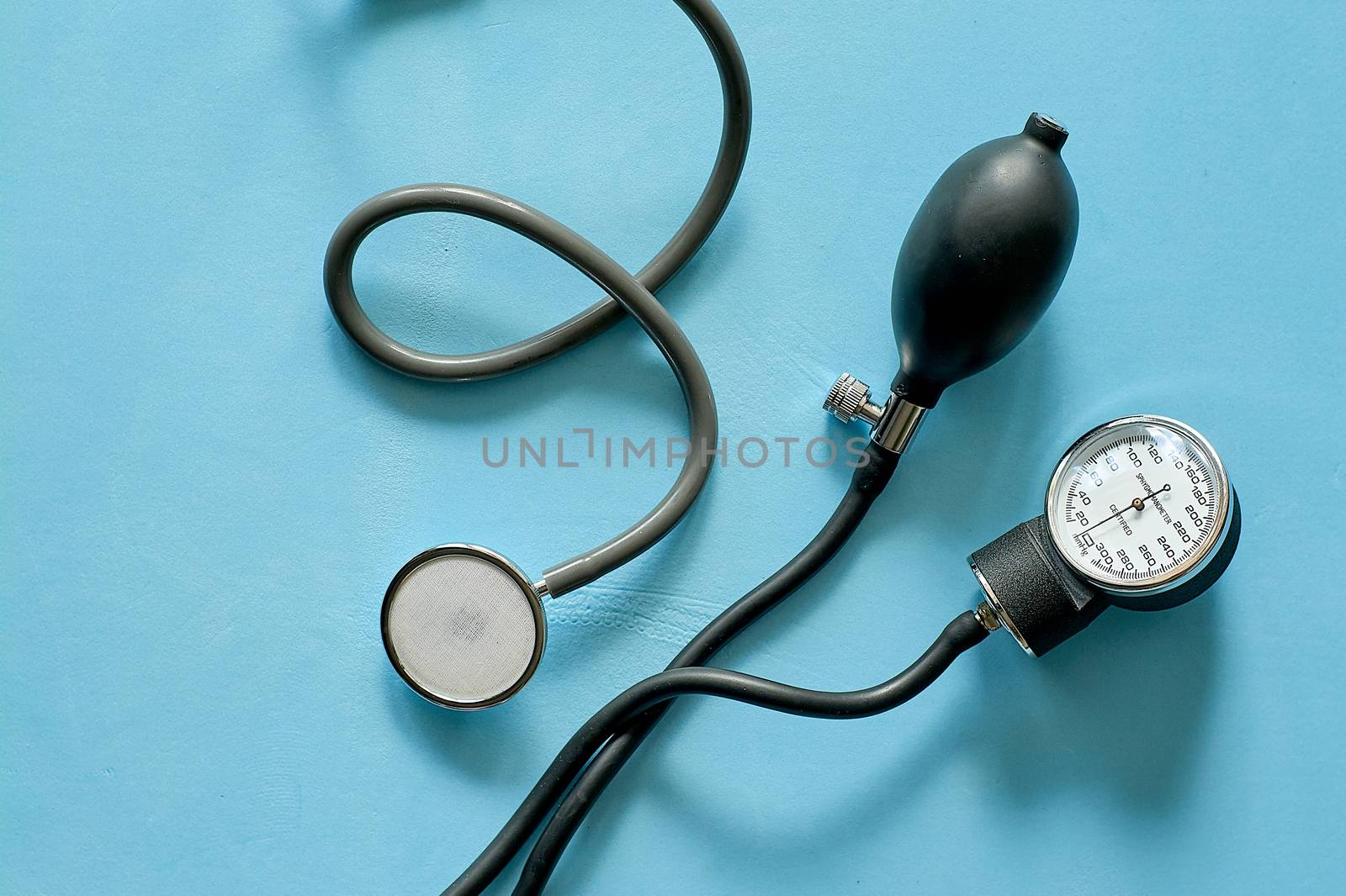 Phonendoscope stethoscope and sphygmomanometer on blue background with copy space for text. Medicine consept. Close-up view.