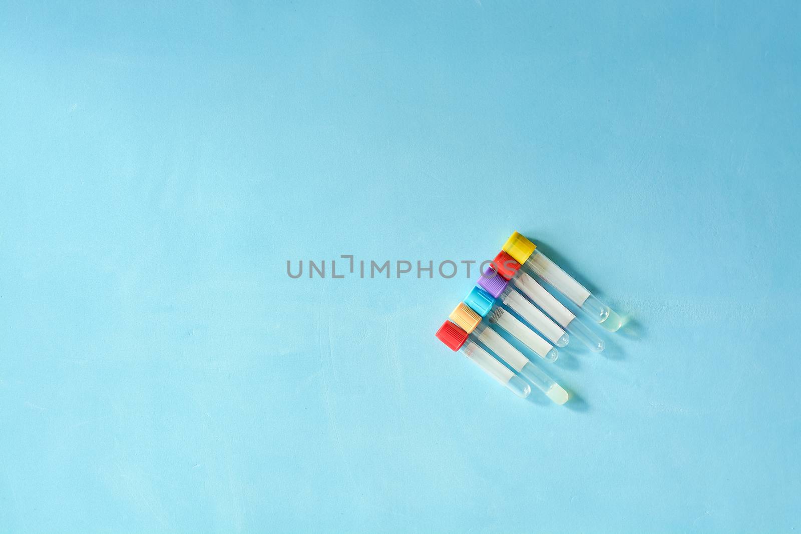 Different color and size empty vacuum venipuncture test tubes. by nixrenas