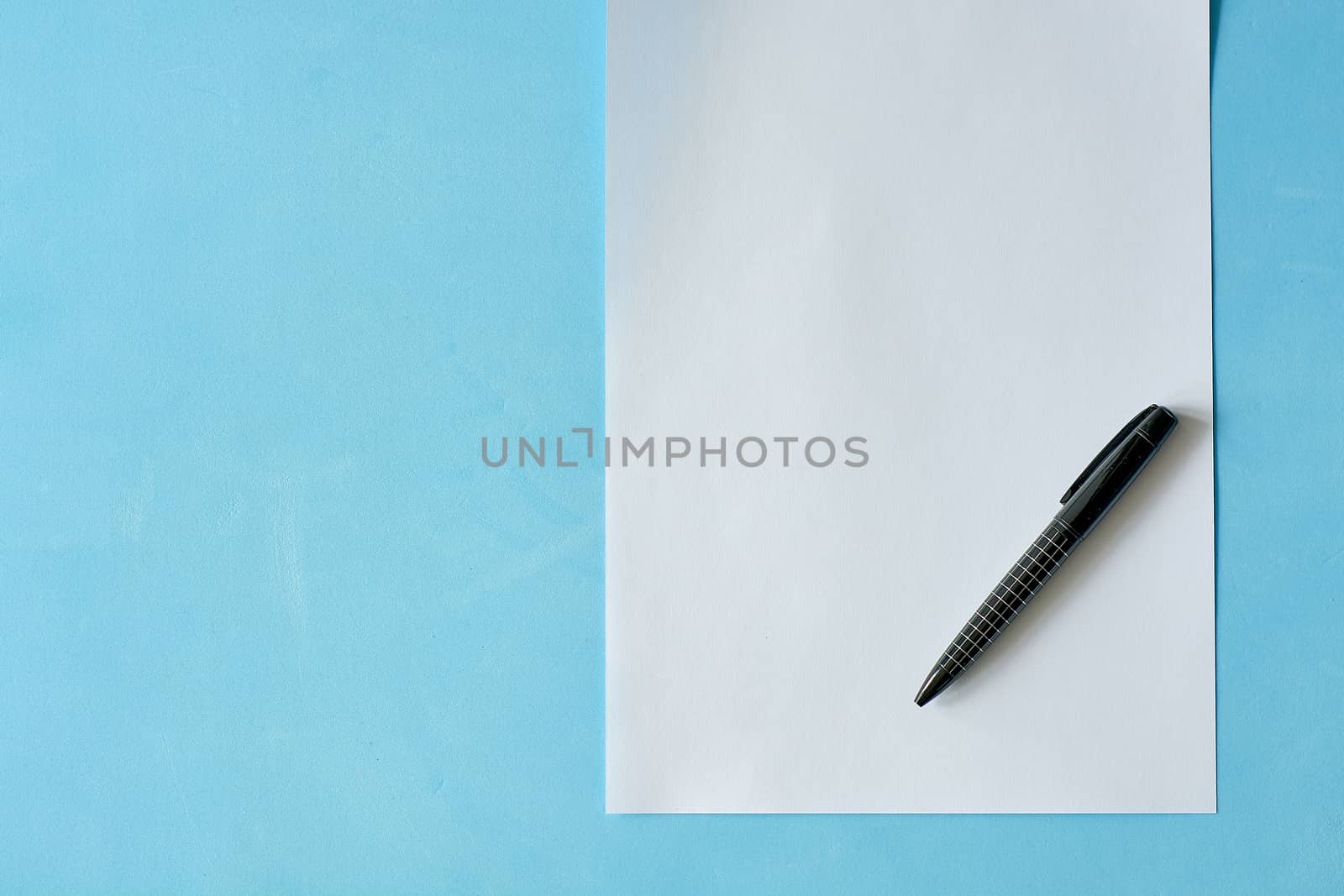 White sheet paper with black pen isoleted on the light blue background. by nixrenas