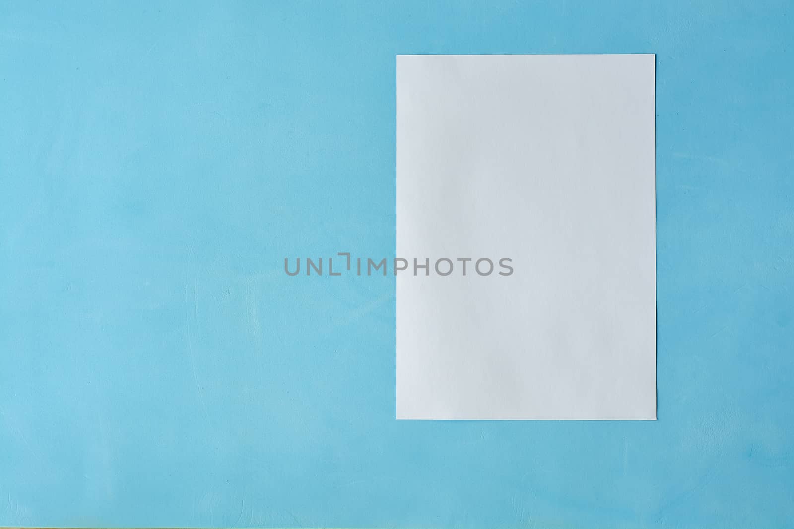 White sheet paper isoleted on the light blue background. by nixrenas