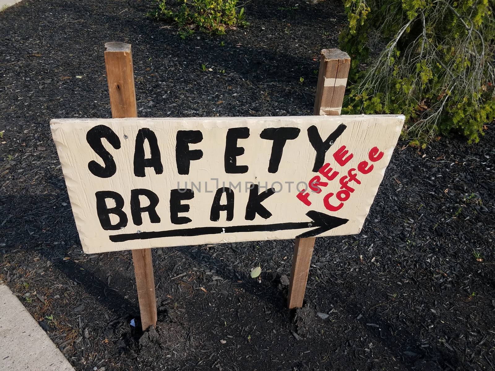 safety break free coffee sign with arrow in ground