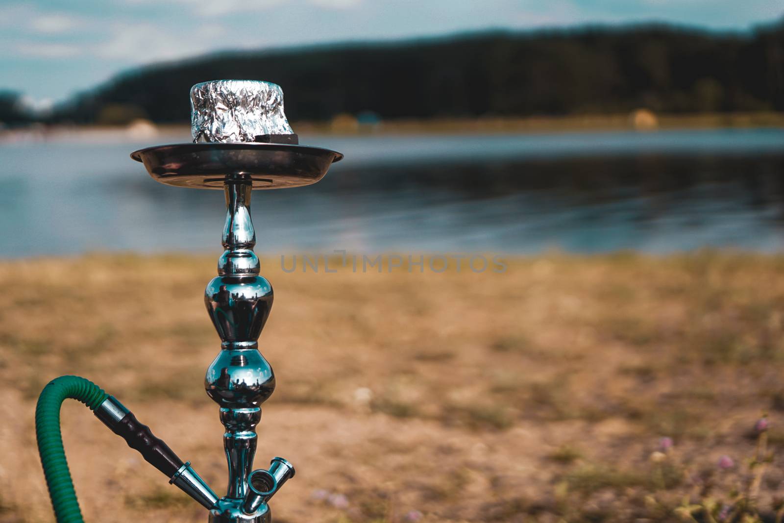Hookah bowl stands in nature by the river close up by natali_brill