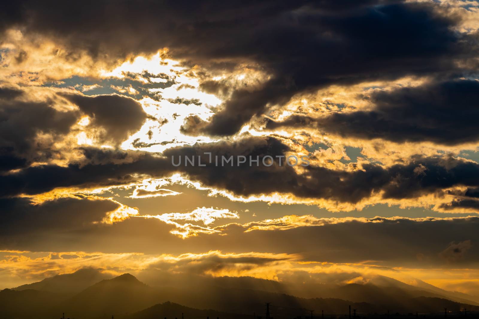 Sunset over mountains with storms clouds
