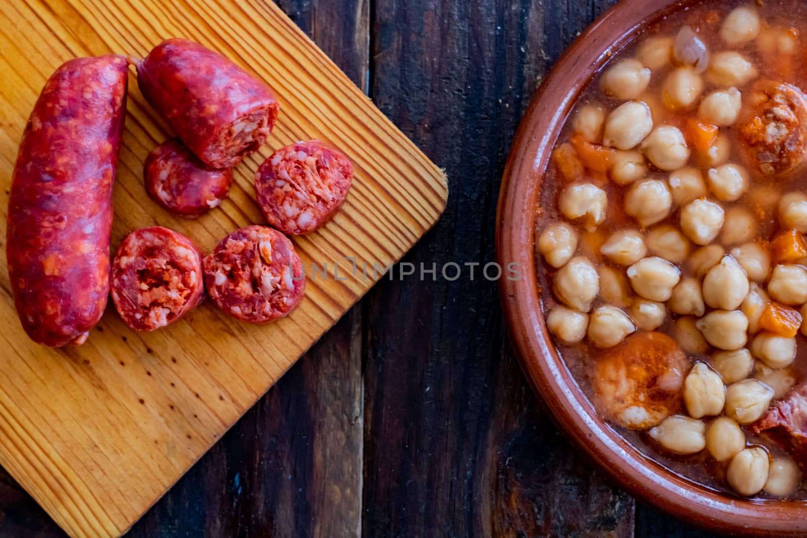 Chickpea dish and ingredients in composition on wooden background