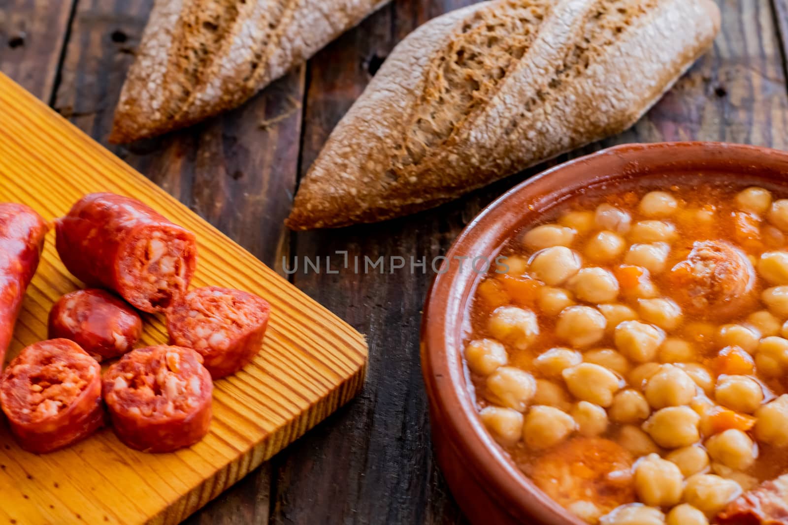Chickpea dish and ingredients in composition on wooden background